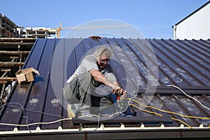 Worker roofer builder working on roof structure