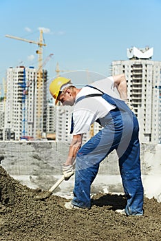 Worker roofer with shovel