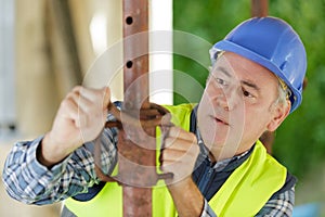 worker with rusty pipe