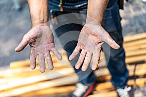 Worker`s hand very hard working in the field of construction carpenter and smith