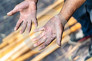 Worker`s hand very hard working in the field of construction carpenter and smith