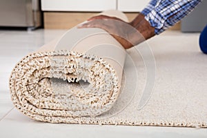 Worker`s Hands Rolling Carpet