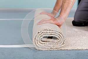 Worker`s Hands Rolling Carpet