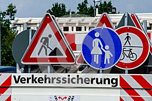 A worker`s truck with roadsigns at a road construction site