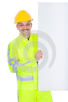 Worker in safety jacket presenting empty board