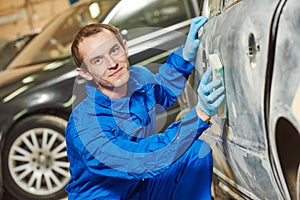 Automobile body sanding with sander. Repair car service photo