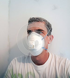 Worker after sanding wall.