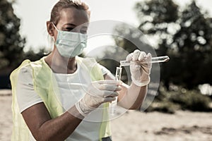 Worker of sanitary service feeling disturbed checking water contamination level