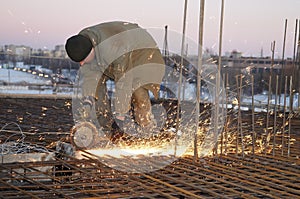 Worker with saw at building