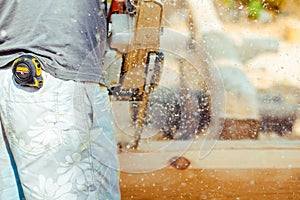 Worker sawing a chainsaw tree