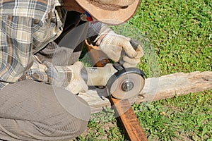 The worker saws a metal profile