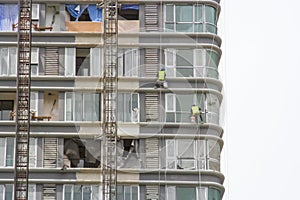 Worker scaffolding on the side of the building