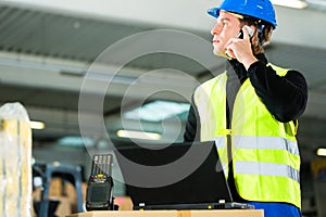 Worker with scanner and laptop at forwarding photo