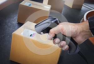 Worker Scanning Bar Code Scanner on Package Boxes. Computer WorkTools for Warehouse Inventory Management.