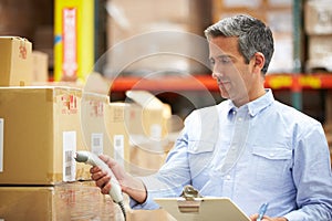 Worker Scanning Package In Warehouse