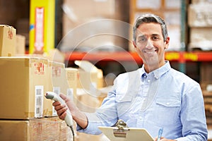 Worker Scanning Package In Warehouse