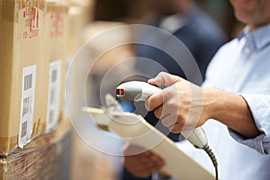 Worker Scanning Package In Warehouse