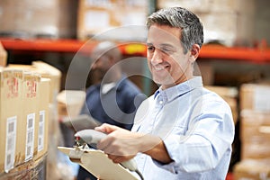 Worker Scanning Package In Warehouse