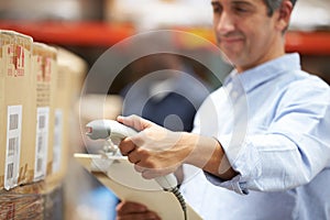 Worker Scanning Package In Warehouse