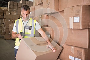 Worker scanning package in warehouse