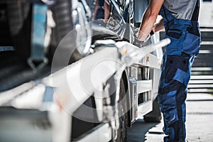 Worker Securing Car on a Towing Truck