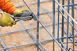 Worker Securing Steel Rebar Framing With Wire Plier Cutter Tool