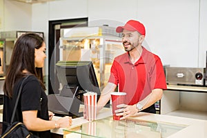 Worker serving food at a concession stand