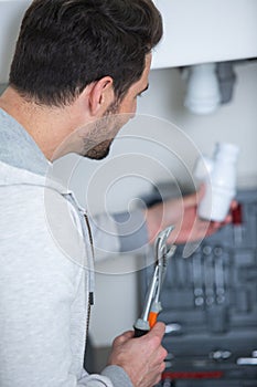 worker set up electric heating boiler at home