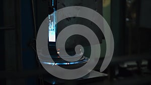 Worker is setting steel round billet of wheel on a circular welding machine.