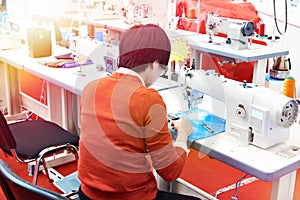 Worker and sewing machine in workshop