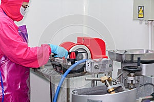 Worker sharpening knife with electric grinding stone