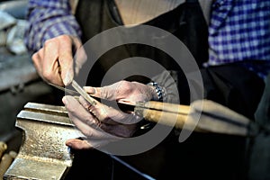 Worker sharpens a knife