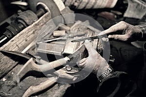 Worker sharpens a knife