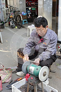 Worker sharpens a knife