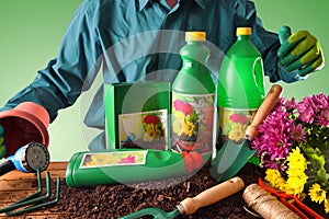 Worker showing bottles and containers of gardening products