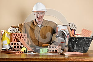 Worker showing construction materials and tools on wooden table