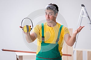 Worker showing the importnace of wearing noise cancelling headph