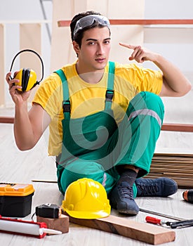 Worker showing the importnace of wearing noise cancelling headph