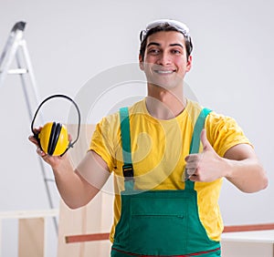 Worker showing the importnace of wearing noise cancelling headph