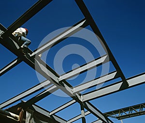 Worker sitting on iron construction low angle view