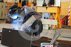 Worker sitting welding