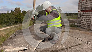 Worker with sledgehammer beats concrete