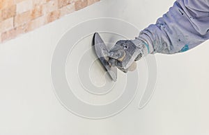 Worker Smoothing Wet Pool Plaster With Trowel photo