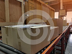 Worker sorting shipment cartons box on pallets and wooden case on hand lift in interior warehouse cargo for export and sorting goo