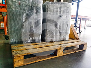 Worker sorting shipment and package box on hand lift pallet in cargo warehouse and ready loading to container truck for transporta