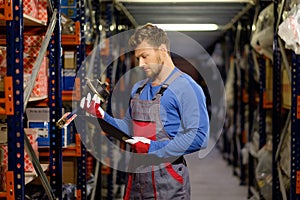 Worker in a spare parts warehouse photo