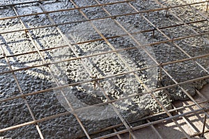 A worker in a special suit is sandblasting metal at an industrial site