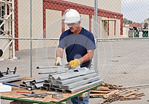 Worker Stacking Metal Studs photo