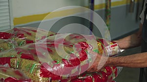 Worker stacking noodle bags in a plastic container