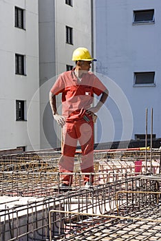 Worker Stands Among Rebar - Vertical
